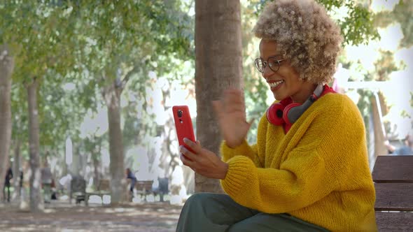 Latin American Woman Making a Video Call with Mobile Phone in the Park