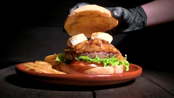 Close Up of an Unrecognizable Chef Finishing Up a Premium Quality Beef Burger with Goat Cheese and