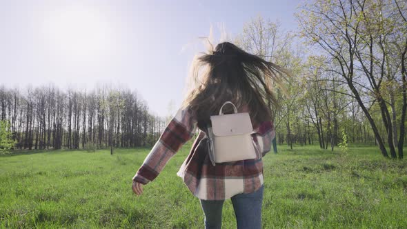 Beautiful Young Woman Walks in Nature