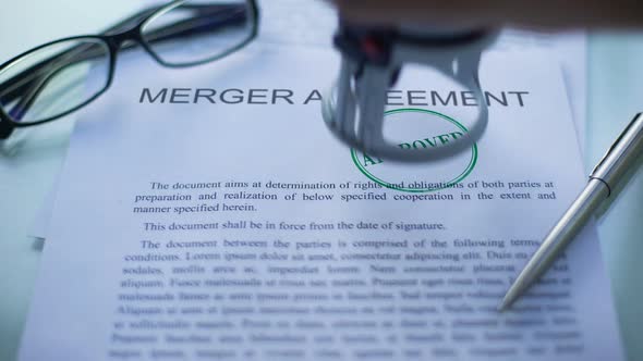 Merger Agreement Approved, Officials Hand Stamping Seal on Business Document