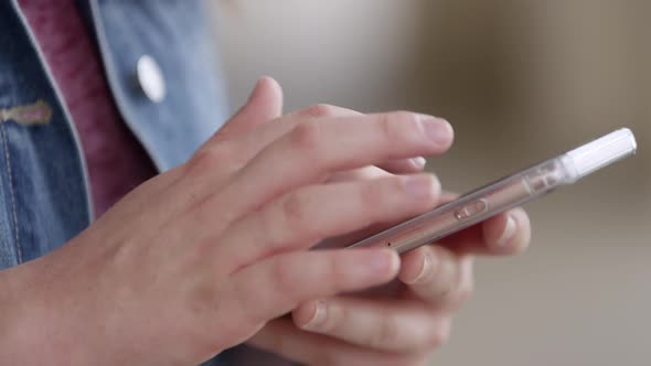 Up close view of person swiping and typing on phone