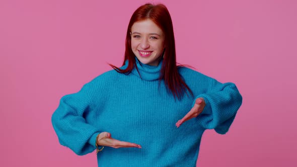 Cheerful Girl in Blue Sweater Looking at Camera Doing Phone Gesture Like Says Hey you Call Me Back