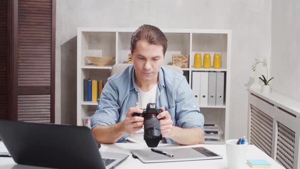 Workplace of freelance worker at home office. Young man works using computer.