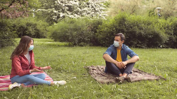 Young, happy, loving couple having date in the park. Relations, friendship and love concept.