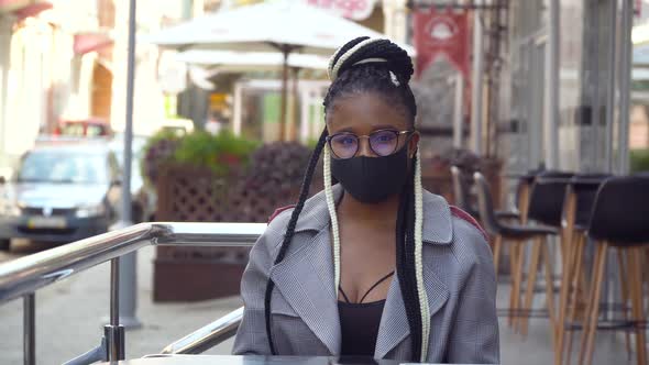 African American Girl Looking at the Camera in Street Cafe