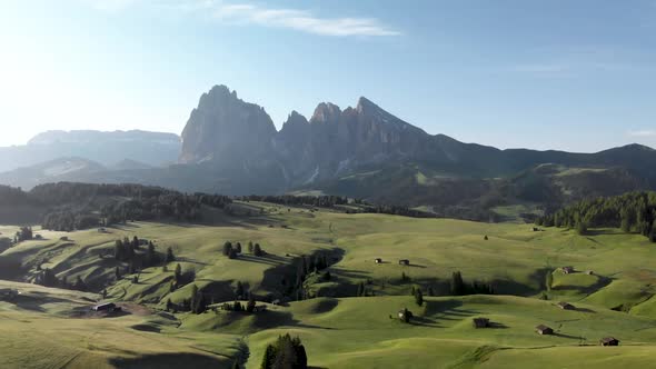 Aerial view of Seiser Alm valley with traditional wooden mountain huts in Dolomites Italy