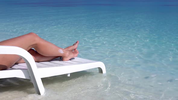 Woman Relax on White Plastic Sunbed at Perfect Calm Beach with Crystal and Turquoise Sea Water