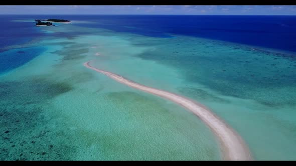 Aerial flying over travel of marine shore beach holiday by shallow lagoon with white sand background