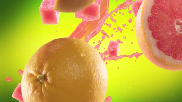 Grapefruit with Slices Falling on Lime Green Background