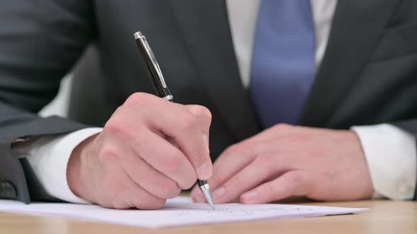 Businessman Writing on Paper 