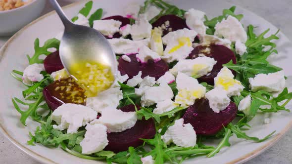 Beetroot and goat cheese salad with nuts and arugula