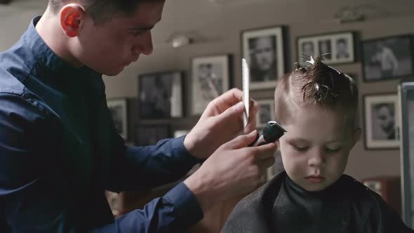 Little Boy Getting Haircut in Barbershop