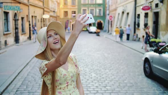 Woman Sightseeing and Taking Shots. Cheerful Girl Sightseeing and Taking Shots on Old Town Street.