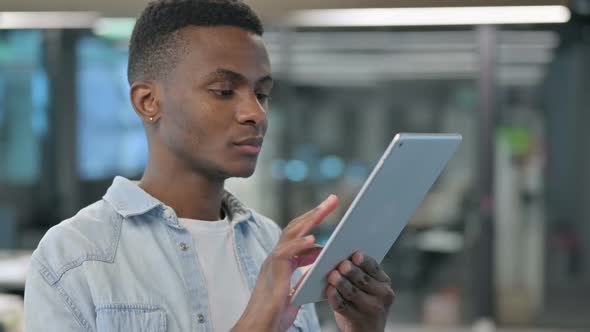 Portrait of African Man using Digital Tablet