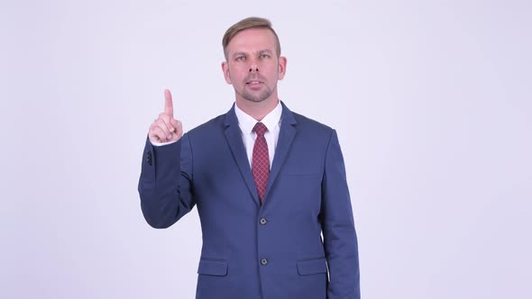 Happy Blonde Businessman Pointing Up