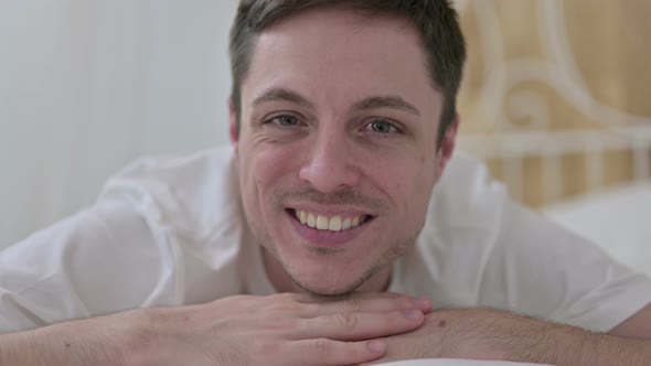 Close Up of Young Man Doing Thumbs Up in Bed