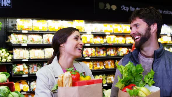 Couple shopping for fruits and vegetables in organic section