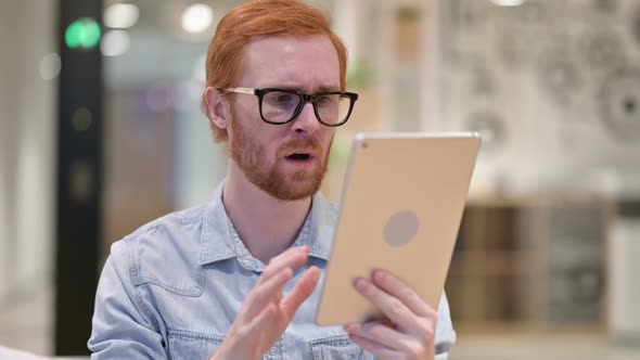 Portrait of Upset Casual Redhead Man Reacting To Loss on Tablet 