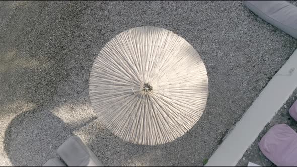 Aerial view of straw umbrella at beach in Panagopoula, Greece.