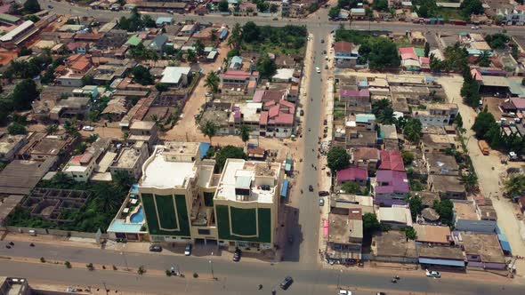 Cinematic Aerial View of African City traffic, showing Twin Towers building, Lomé, West Africa