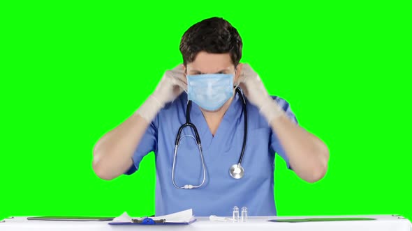 Male Doctor Wearing a Protective Mask. Green Screen