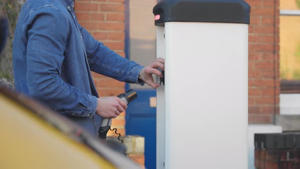 slow motion Electric car on charge  outside house