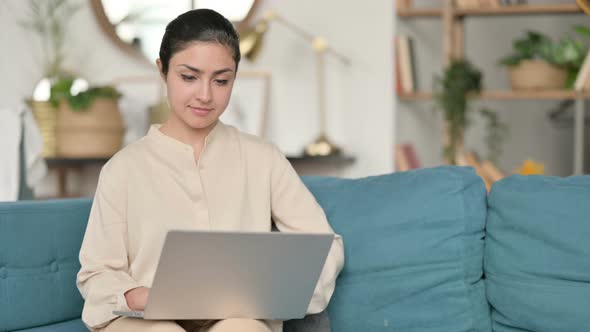 Indian Woman Using Laptop on Sofa 