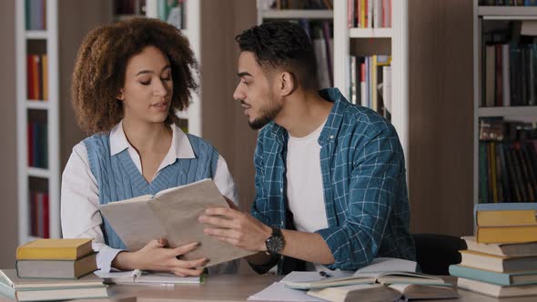 Two Diverse Students Sitting in University Library Preparing for Exam Studying Young Guy Arguing