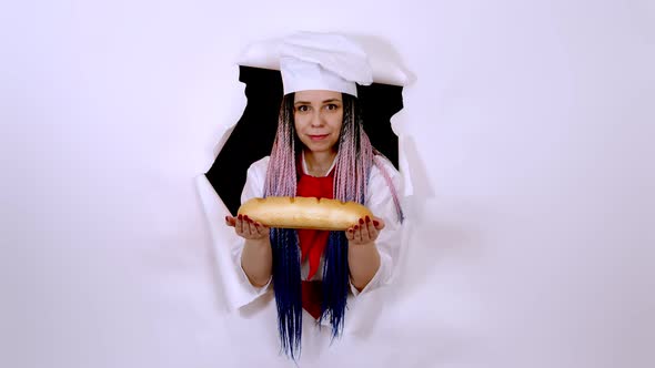 Young Woman Dressed As Chef Holding White Bread