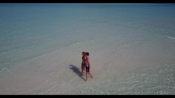 Guy and girl tanning on luxury island beach adventure by blue green ocean and white sand background 