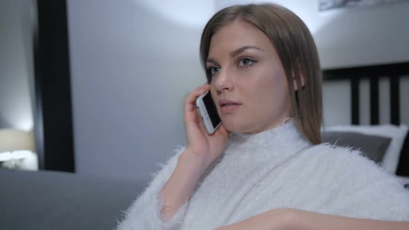 Woman Talking on Phone, Sitting on Couch in Bedroom