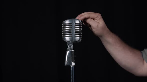 Person tapping microphone and speaking is this thing on
