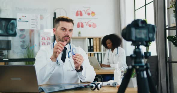 Doctor Explaining for Online Audience through Camera How to Use Pulse Oximeter