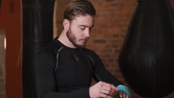 Boxer Is Putting Boxers Gloves on His Hands Preparing To Spar