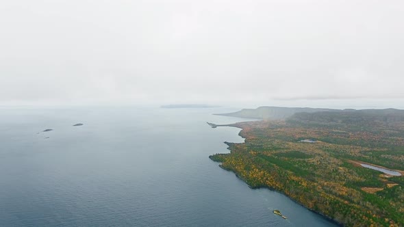 Aerial camera shoots a horizon above a lake and coast in Lake Superior, Great Lakes, Ontario, Canada