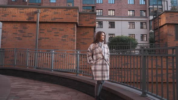 Attractive Girl of European Appearance Walks Down the Street Smiling