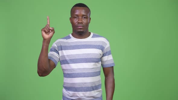 Young African Man Pointing Finger Up