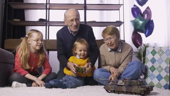 Little Cute Boy Learning To Use Remote Control Toy