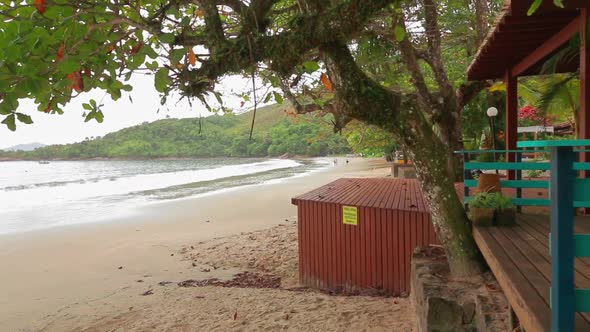 First person view of  wooden house surrounded by the beach and tropical trees. Real time. Fortaleza,