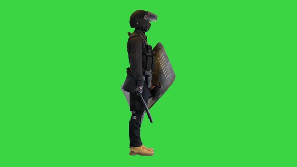 Special Unit Riot Policeman with a Shield and Baton Standing Waiting on a Green Screen Chroma Key