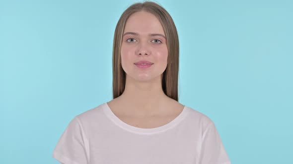 Beautiful Young Woman Saying Yes By Head Shake, Blue Background