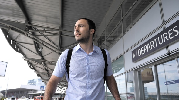 Man looking for the right terminal outside the airport