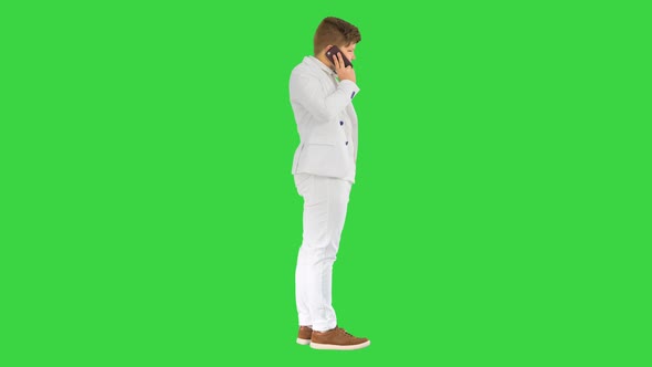 Businessman Boy Making a Call with Smartphone on a Green Screen Chroma Key
