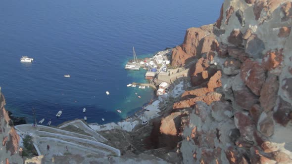 Shot from a high angle a small fishing harbor and the steep stairs that lead to it. Kamari fishing h