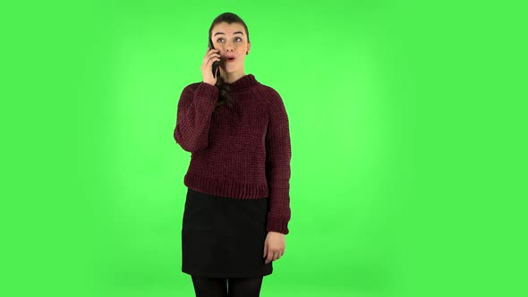 Smiling Girl Talking for Mobile Phone and Rejoice. Green Screen