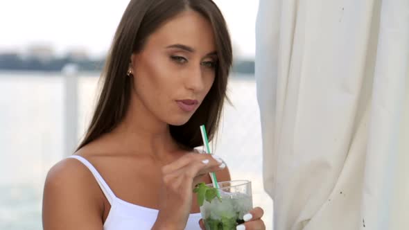 Young Beautiful Stylish Girl Drinks a Cocktail Beautiful Brunette