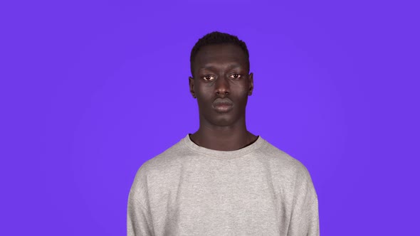 Front View Portrait of Young Serious Calm Man Staring at Camera