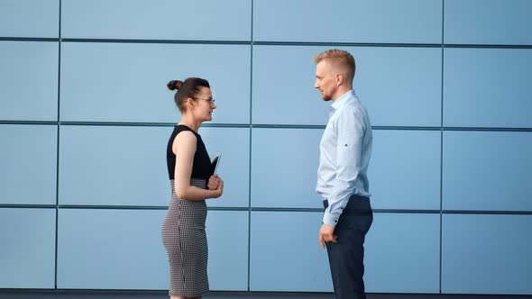 Businessman and Businesswoman Having Informal Meeting Outdoor Shaking Hands