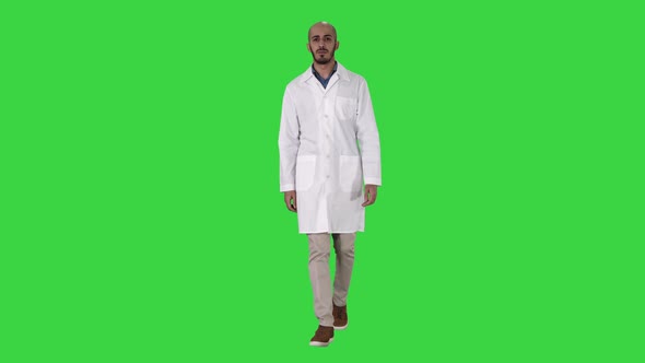 Friendly Male Doctor Walking and Talking Looking in Camera on a Green Screen, Chroma Key.
