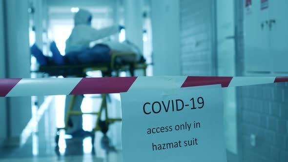 Quarantined Corridor with a Doctor and a Rolling Table. Coronavirus Hospital, COVID-19 Clinic